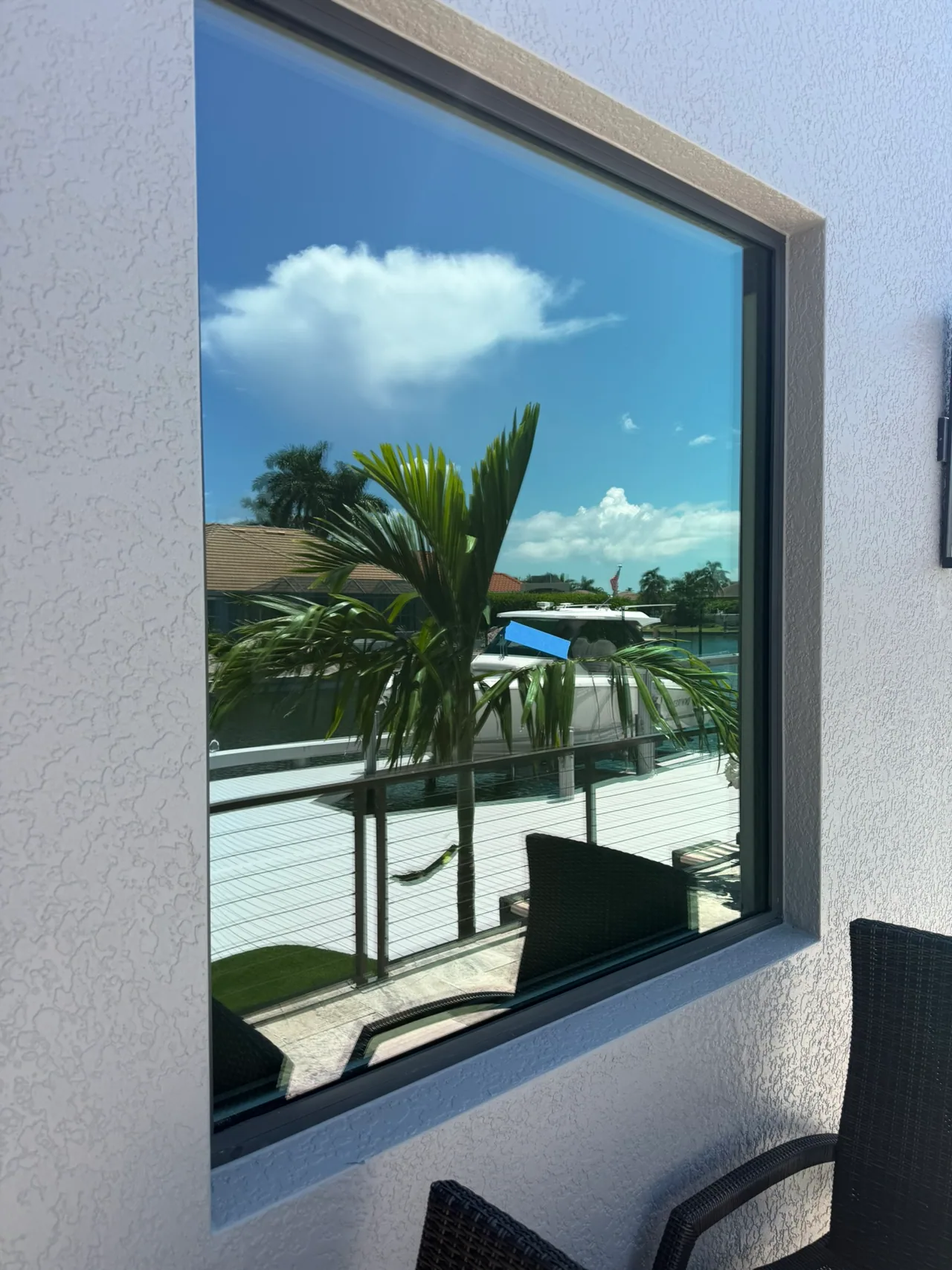 Reflective Low-E window on Marco Island waterfront home causing artificial turf burn